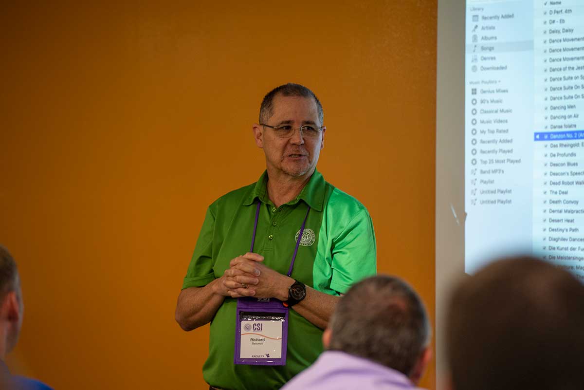 Richard Saucedo talking to attendees at the Conn-Selmer Institute.